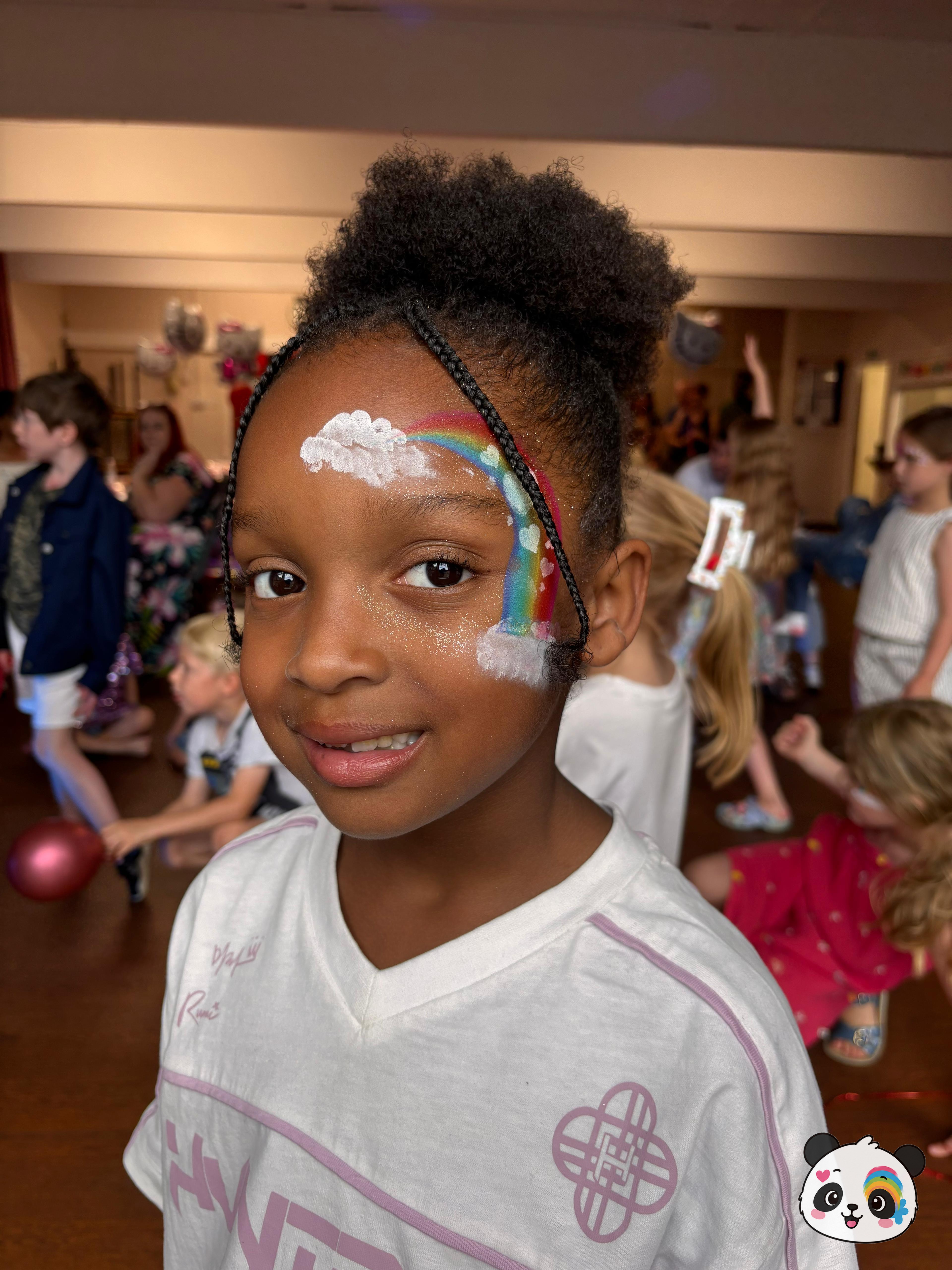 A colorful rainbow arching over the forehead and temple, accented with white clouds and subtle glitter.