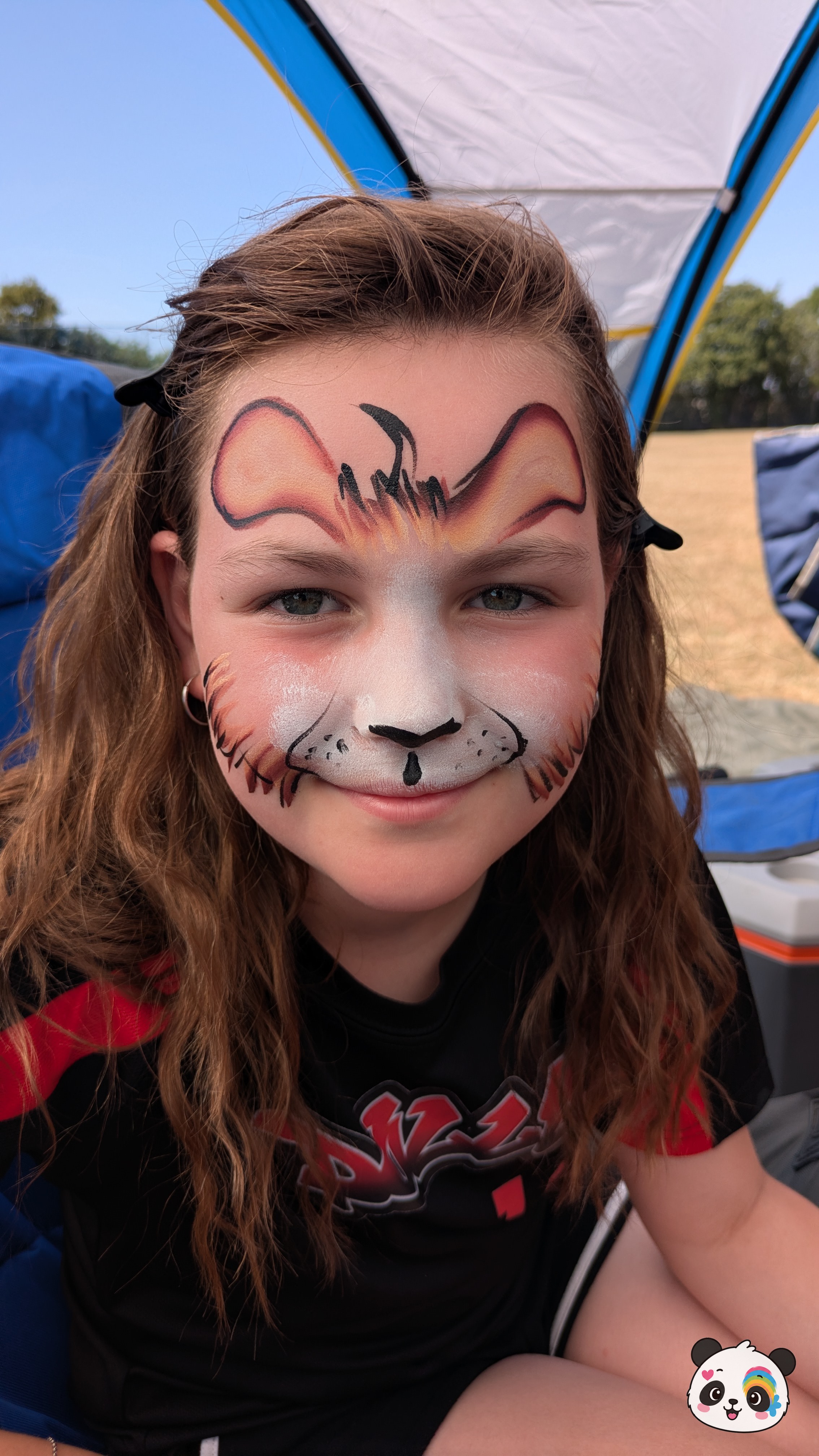 Mouse face paint design featuring large ears on the forehead, a white muzzle, and whiskers in shades of orange, brown, and white.