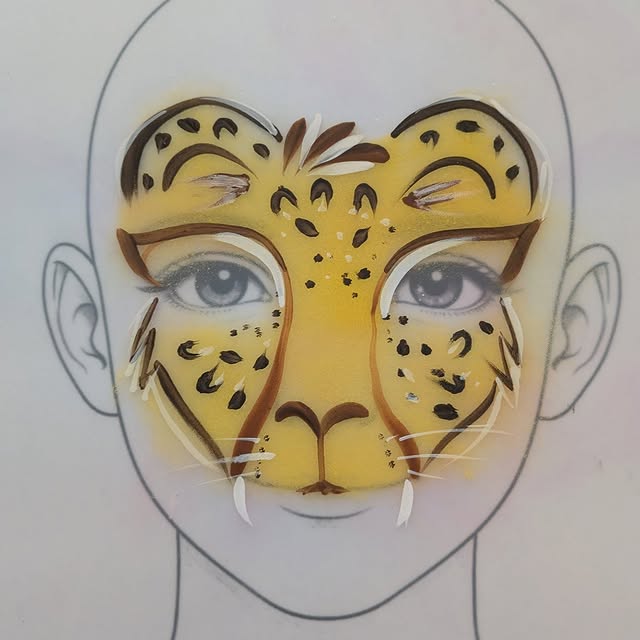 Leopard face paint design on a white practice board