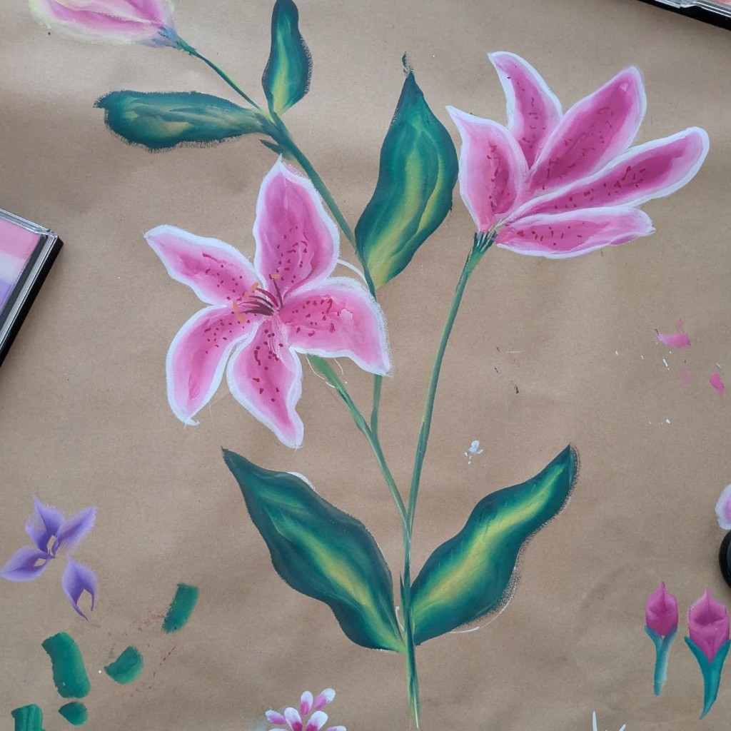 Pink lily flowers painted on a practice board showing one-stroke technique